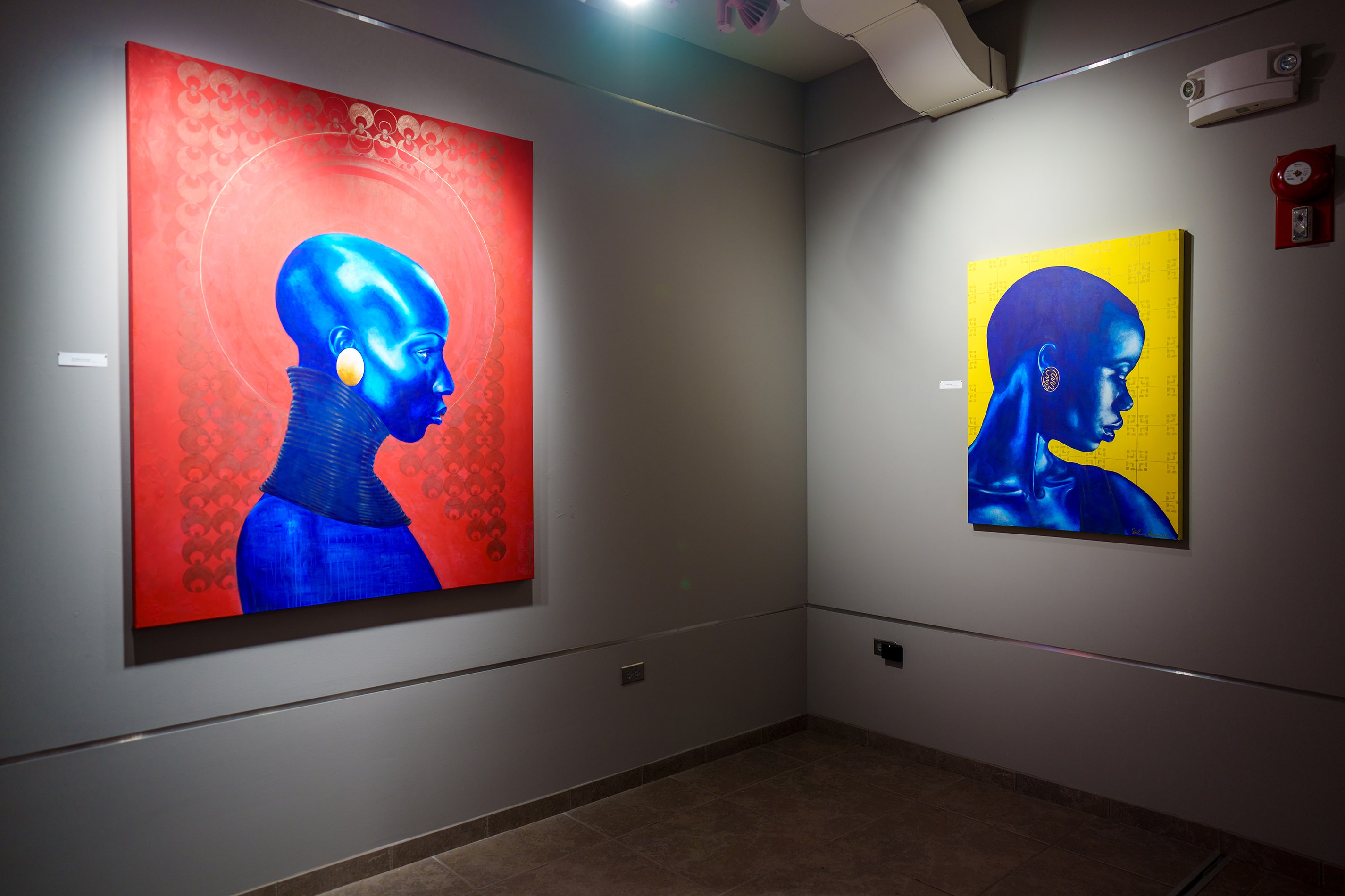 A pair of paintings on display at an exhibition