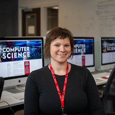 Graduate student in front of a compuyer