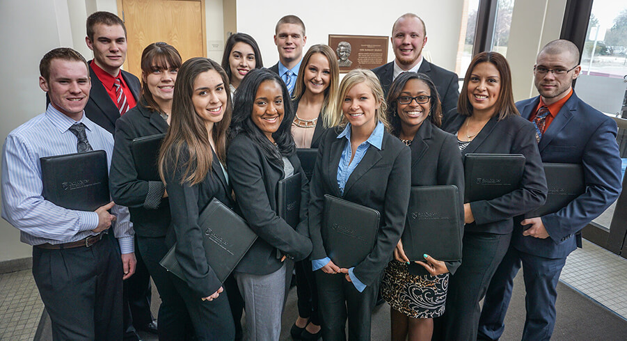 Group of business students together with portfolios