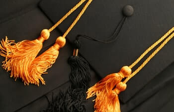 Honors Cords with a black cap background