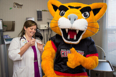Champ the Cougar getting vaccinated at the Health Center