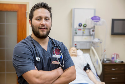 Male nursing student in front of simmulation mannequin