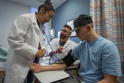 Nursing faculty assisting a nurse educator student