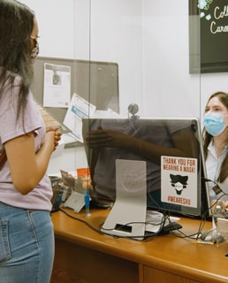 Student speaking with a staff member