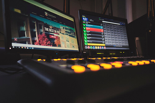 Two computer monitors and a soundboard