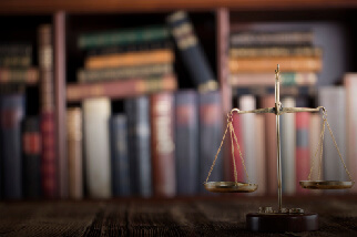 graphic with scales on a desk and books behind it