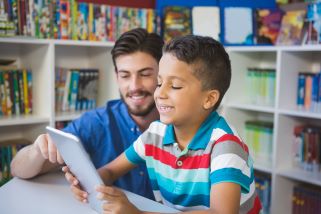 Teacher working with student in classroom