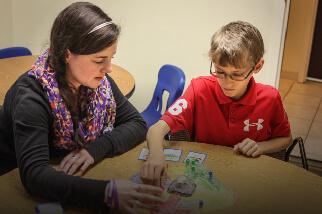 Teacher working with young student