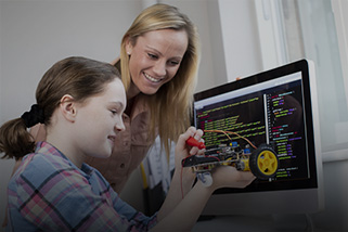 Teacher with student near a computer