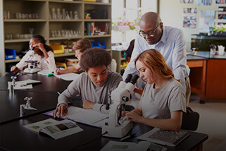 Teacher assisting high school student in the classroom