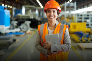 Woman in a hard hat looking at the camera