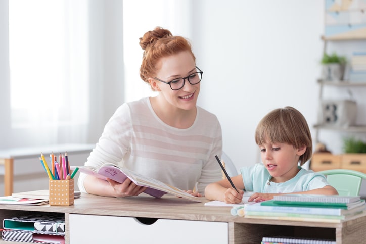 Teacher helping out young student in 1-on-1 lesson