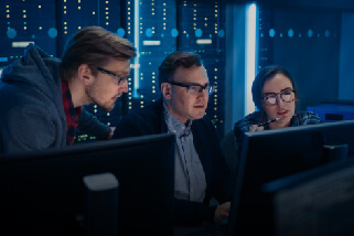 Several coworkers having discussion in front of computer 