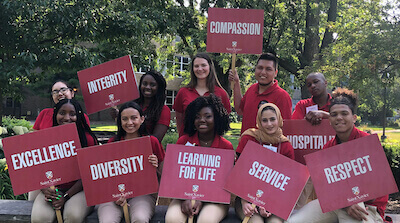 Via leaders with the core value signs in the SXU quad near the arch