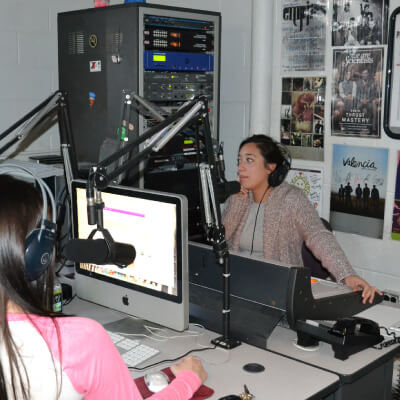 Two ladies working at the radio station, WXAV